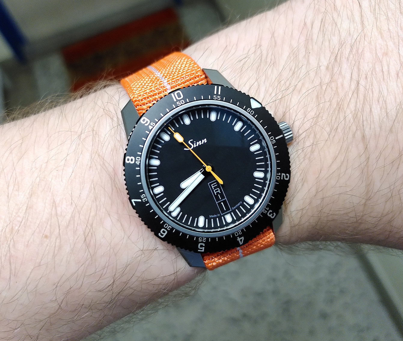 Sinn 105 St Sa on an orange elastic woven nylon strap (by Bilun). The bezel is set to UTC